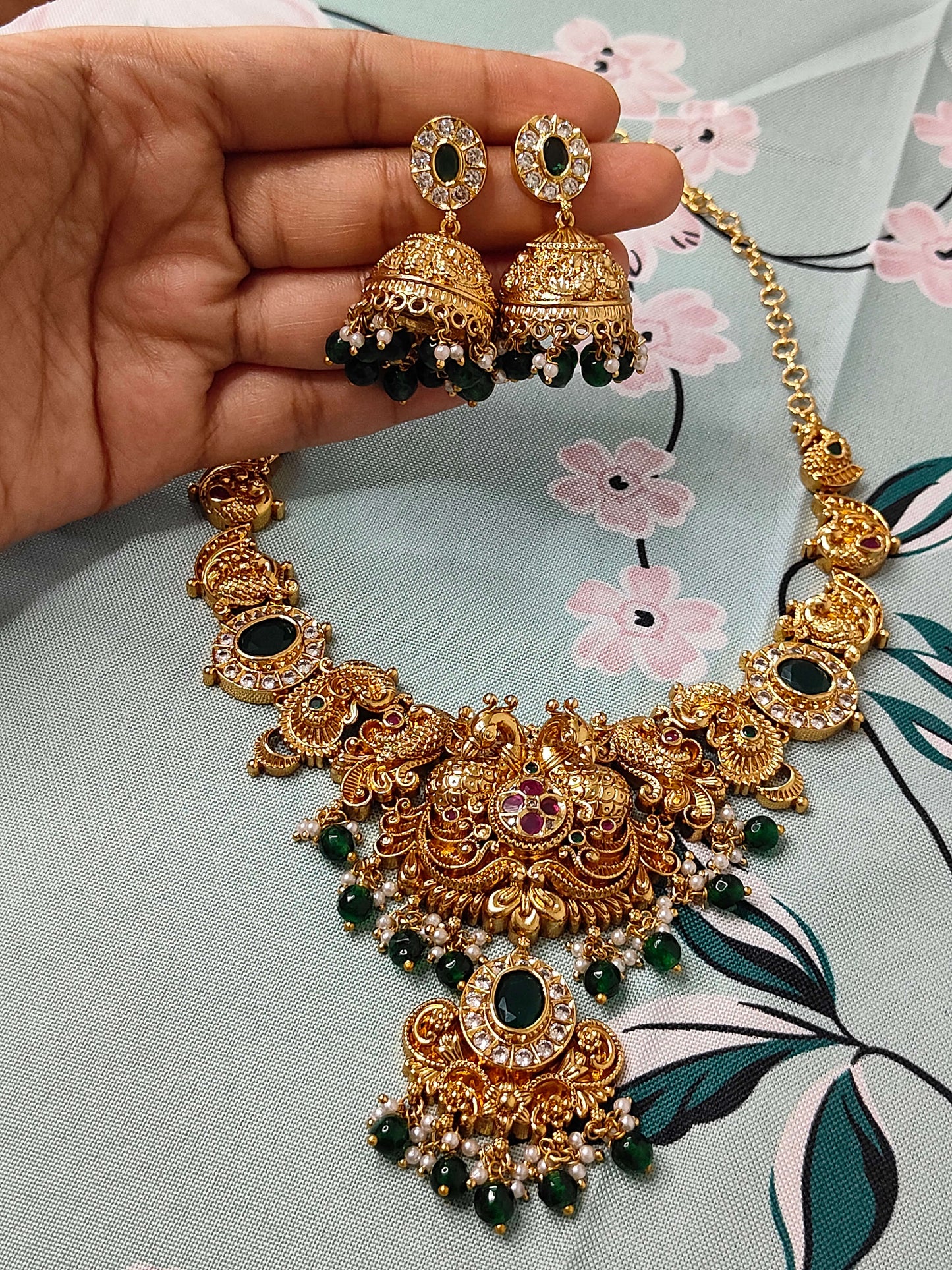 Traditional temple haram set with green and white pearls paired with jumkas