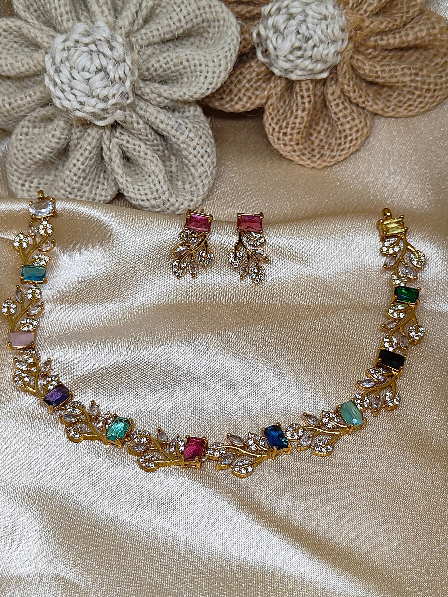 Leaf design necklace with multicolour stones.