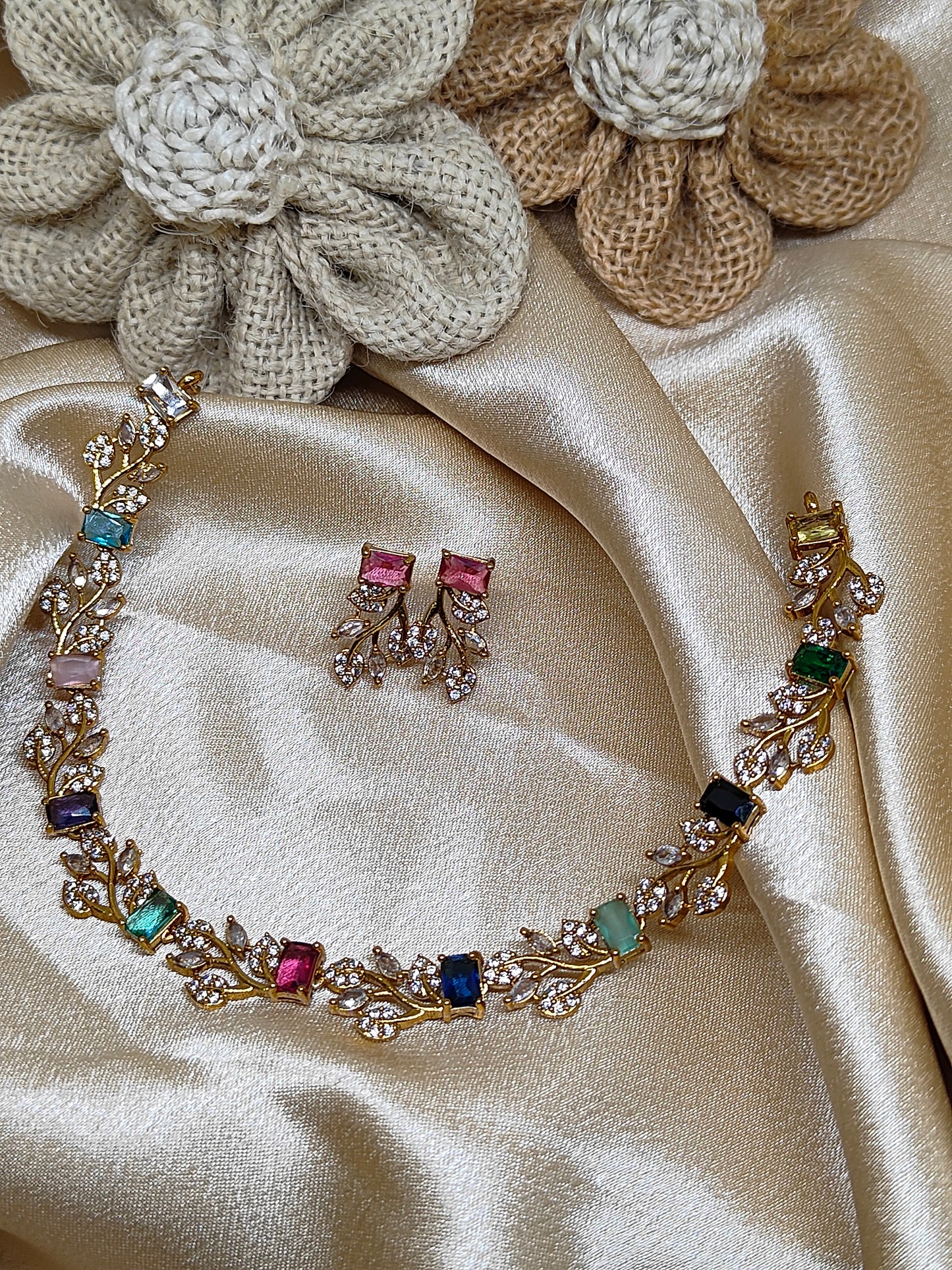 Leaf design necklace with multicolour stones.