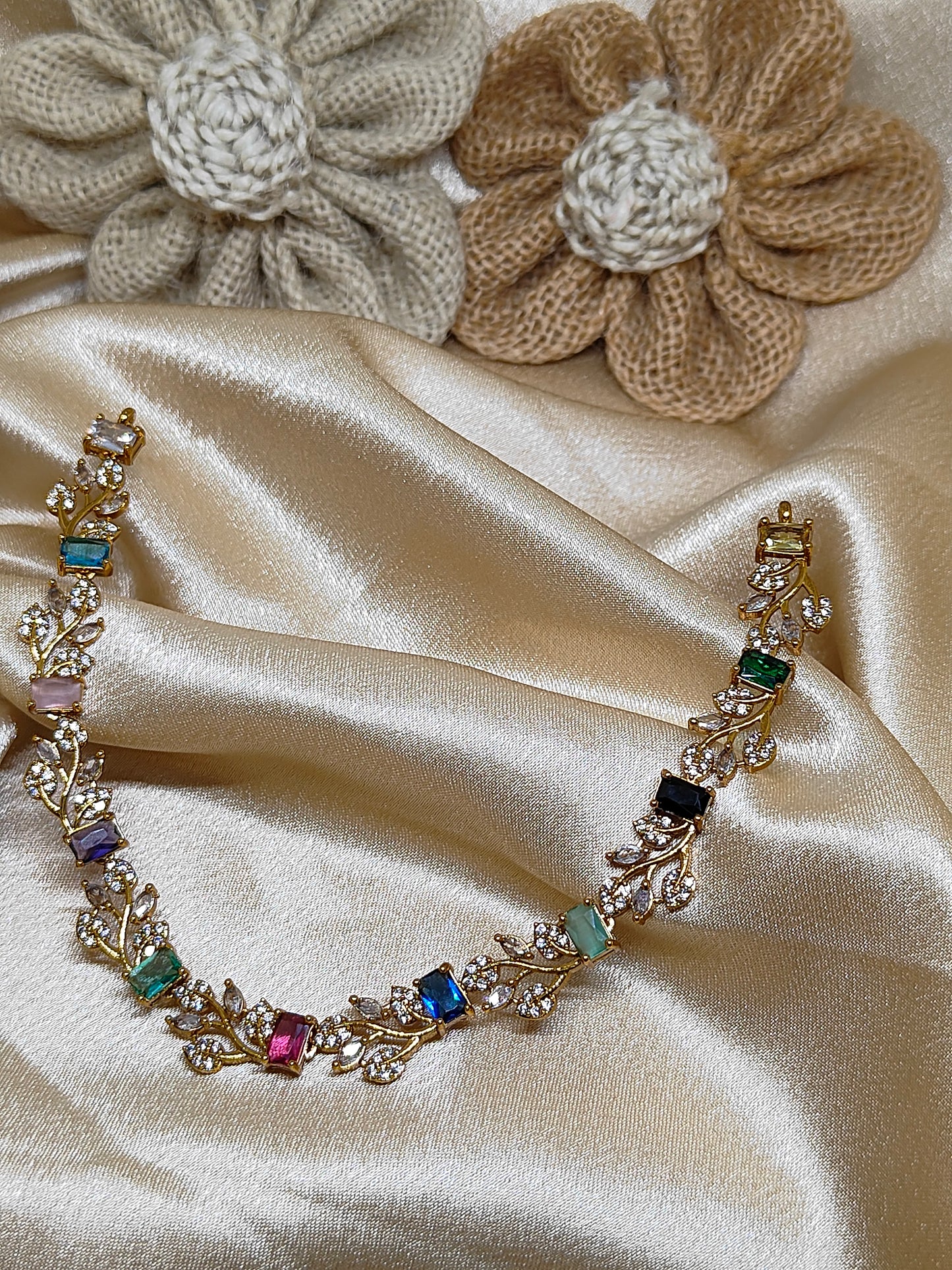Leaf design necklace with multicolour stones.